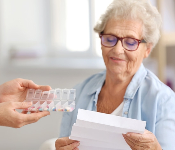 Elderly woman studying her new prescription drug plan, like those offered by the Medicare Store and Agency4RED.
